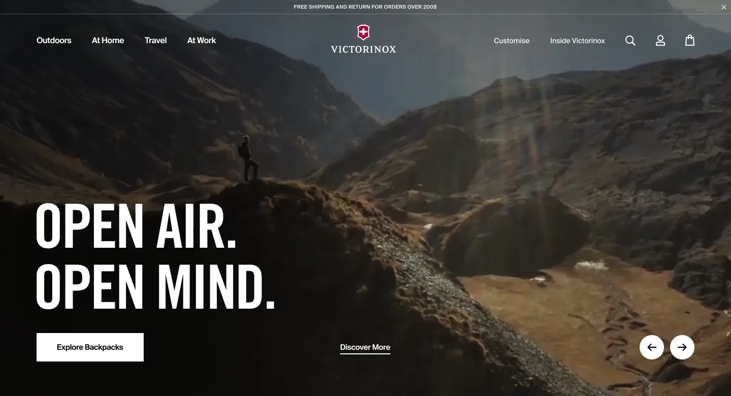 A man standing on top of a mountain with the words open air, open mind